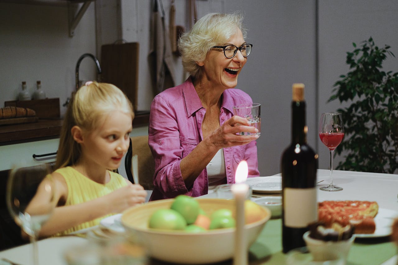 A heartwarming dinner scene featuring a joyful grandmother and a child enjoying quality time together.